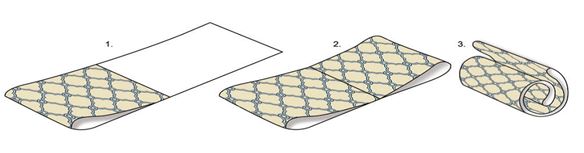 Folding a patterned fabric into thirds.
